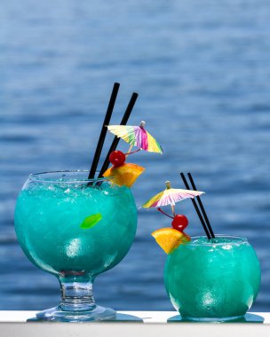 mavi kokteyl bir balık kase hizmet bir seyahat kavram olarak doğal su arka planı olan bir korkuluk yılları arasında görev yapmıştır