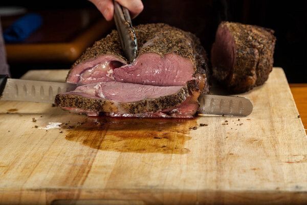 Close up of a large Prime rib roast being sliced for dinner service