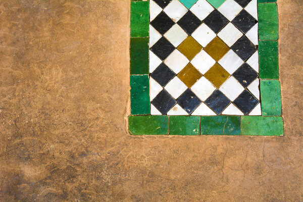 Moroccan ceramic tiles and plaster background in Marrakesh