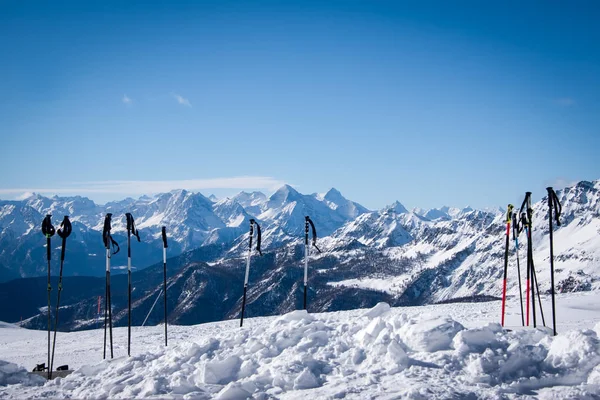 Ski poles on the background of a snowy winter in the mountains . — Stock Photo, Image