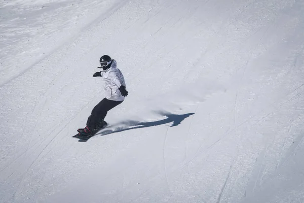 Young guy snowboarder is riding with snowboard from powder snow hill . — Stock Photo, Image