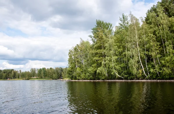 Letní pohled na jezero Hallanlahti s odrazem mraků na vodě . — Stock fotografie