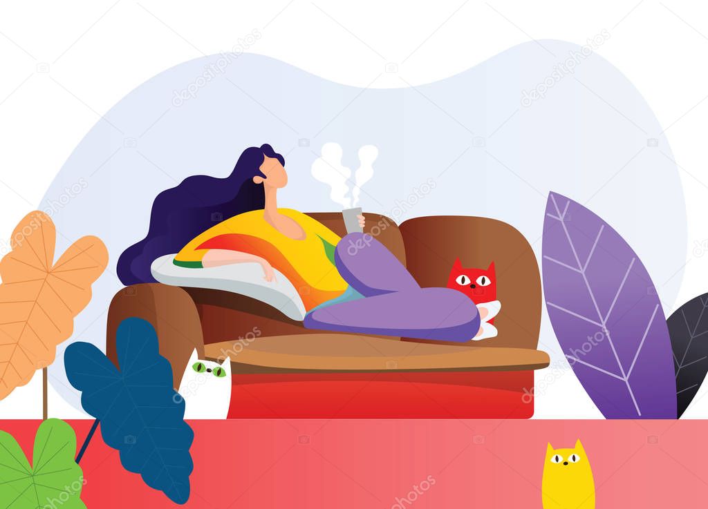 young woman lying on sofa in living room and holding a cup of ho