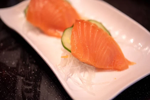 Raw salmon slice or salmon sashimi in Japanese style.