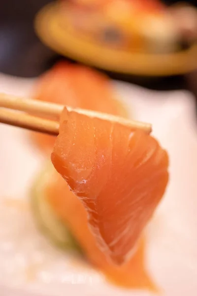 Raw salmon slice or salmon sashimi in Japanese style.