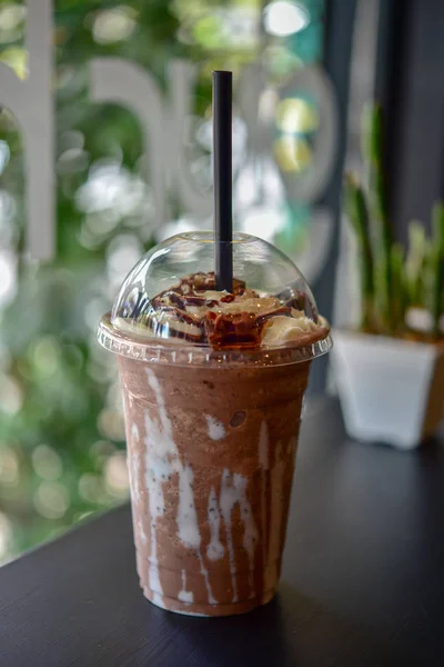 Mocha ice coffee.  Ice chocolate on a table. Chocolate smoothie (milkshake) with jar in cafe. chocolate frappe. Ice chocolate with whipped cream on table