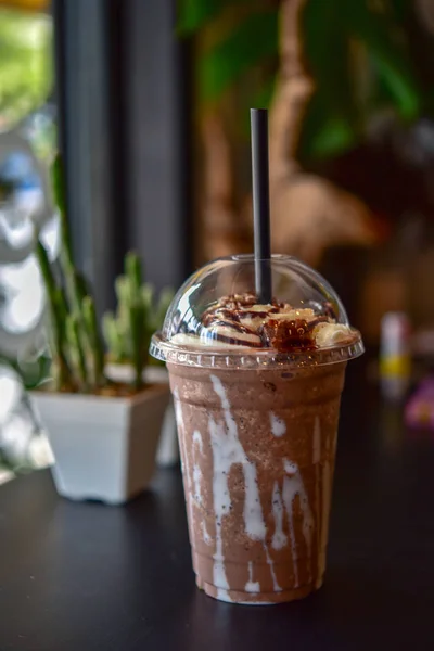 Mocha ice coffee.  Ice chocolate on a table. Chocolate smoothie (milkshake) with jar in cafe. chocolate frappe. Ice chocolate with whipped cream on table