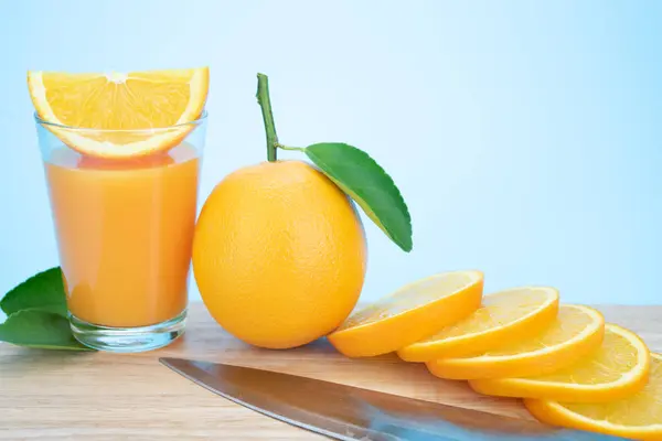 Апельсиновий сік і апельсини з листям — стокове фото