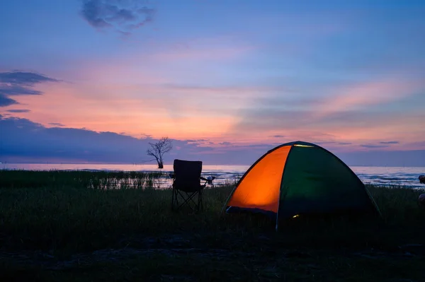 Tent and chairs by the lake — ストック写真