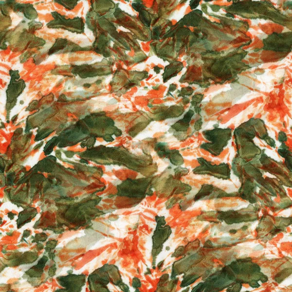 Seamless tie-dye pattern of  orange and green color on white silk. Hand painting fabrics - nodular batik. Shibori dyeing.