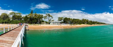 HERVEY BAY, AUS - APRIL 1 2018: People enjoying nice summer day on a beach in Hervey Bey, Queensland, Australia clipart