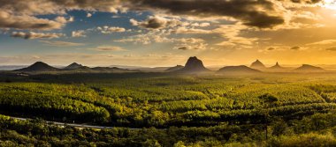 Panoramic view of Glass House Mountains at sunset visible from Wild Horse Mountain Lookout, Australia clipart