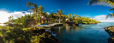 Panoramic paradise holoidays location with coral reef and palm trees on south side of Upolu, Samoa Islands. clipart