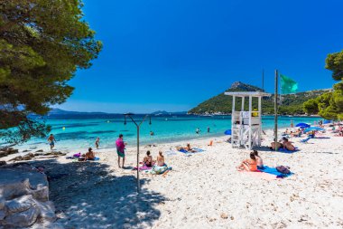 Platja de Formentor, Mallorca, Spain - July 20, 2020: People enjoying the popular beach in summer, Mallorca, Spain. clipart
