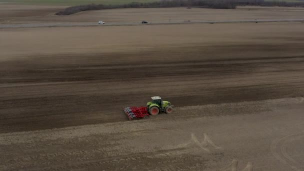 Big Tractor Harrowing Ploughed Field — Stock Video