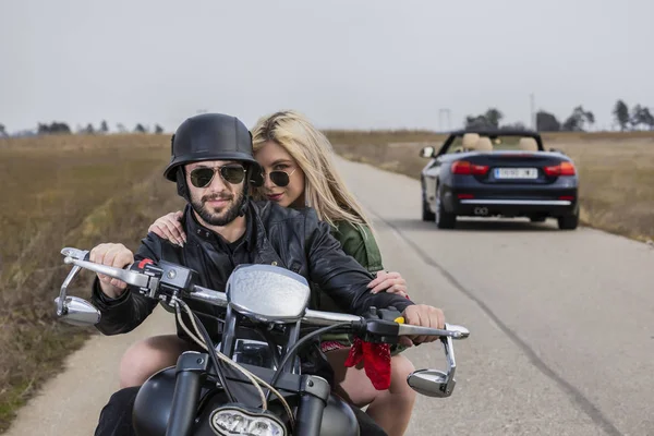 Beautiful young couple traveling Motorbike