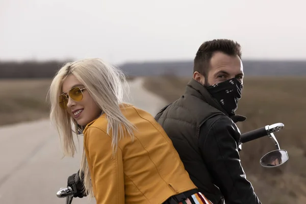 Beautiful young couple traveling Motorbike