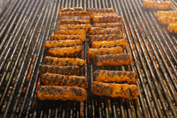 Meat rolls (mititei, mici) on the grill which is a traditional B — Stock Photo, Image