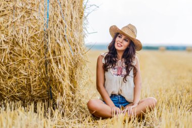 Güzel kovboy kadın samanlıkta poz veriyor, moda konsepti..