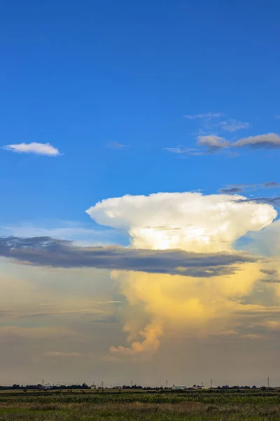 giant white cloud in the form of a mushroom in blue skies. beautiful cloudscape.