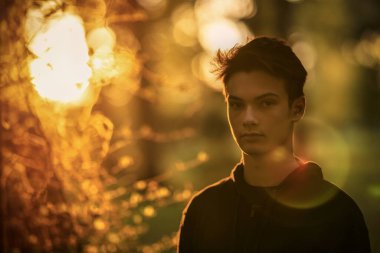 Sonbahar doğal ortamında sonbahar kıyafetleri içinde genç ve yakışıklı bir adam.