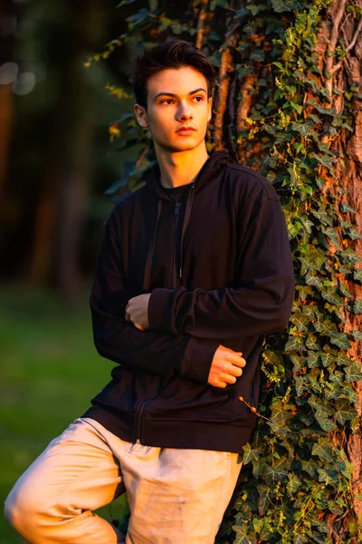 Young handsome man outdoors in fall clothing with autumn natural surroundings