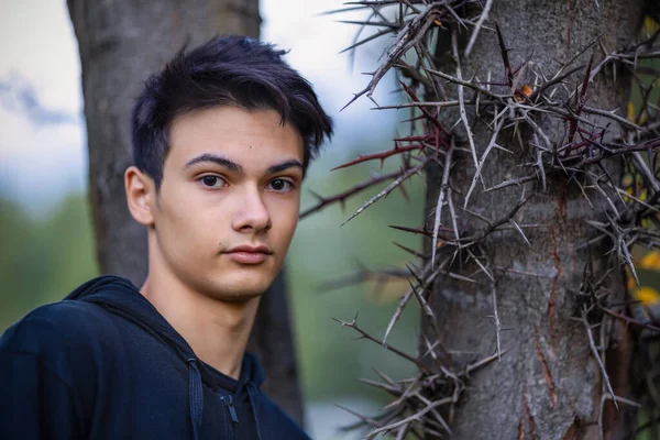 Young handsome man outdoors in fall clothing with autumn natural surroundings