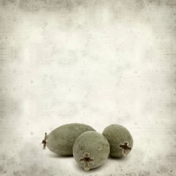 緑フェイジョア果実とテクスチャの古い紙の背景 — ストック写真