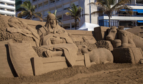 LAS PALMAS DE GRAN CANARIA, SPAIN - DECEMBER 03: Visitors admire Belen de Arena, Nativity scenes made of sand, on Las Canteras town beach, December 03, 2018 in Las Palmas de Gran Canaria, Spain