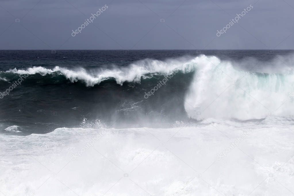 natural background of foamy ocean waves breaking by the shores of Gran Canaria