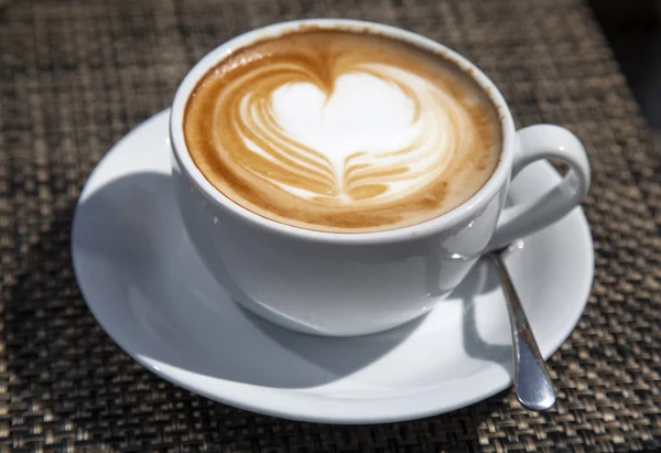 Cappuccino in an outdoors cafe — Stock Photo, Image