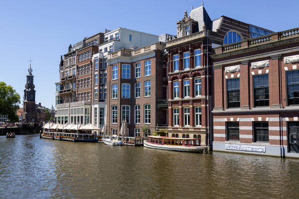 Amsterdam, Netherlands - July 02, 2018: The embankment of the Amstel River in the center of Amsterdam