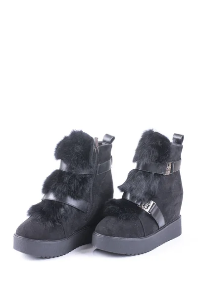 Female winter boots on high soles on a white background