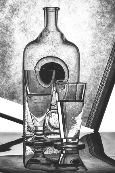 Black and white still life with glass bottles and glasses