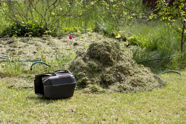 Stack of fresh cut grass on the lawn