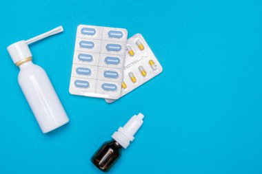 Soğuk algınlığı ve grip tedavisinde. Çeşitli ilaçlar, spreyler tıkalı burun ve Boğaz üzerinde mavi bir arka plan baş belası. Uzay kopyalayın. Tıp düz yatıyordu