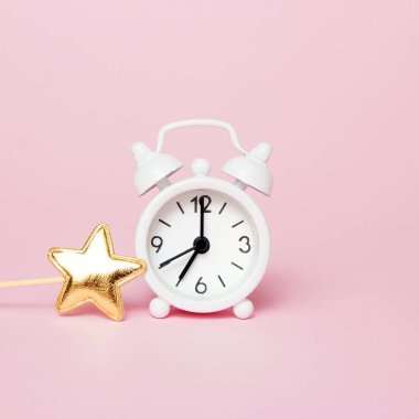 Pembe arka plan üzerinde parti dekorasyonu ile Retro çalar saat. Kopyalama alanı