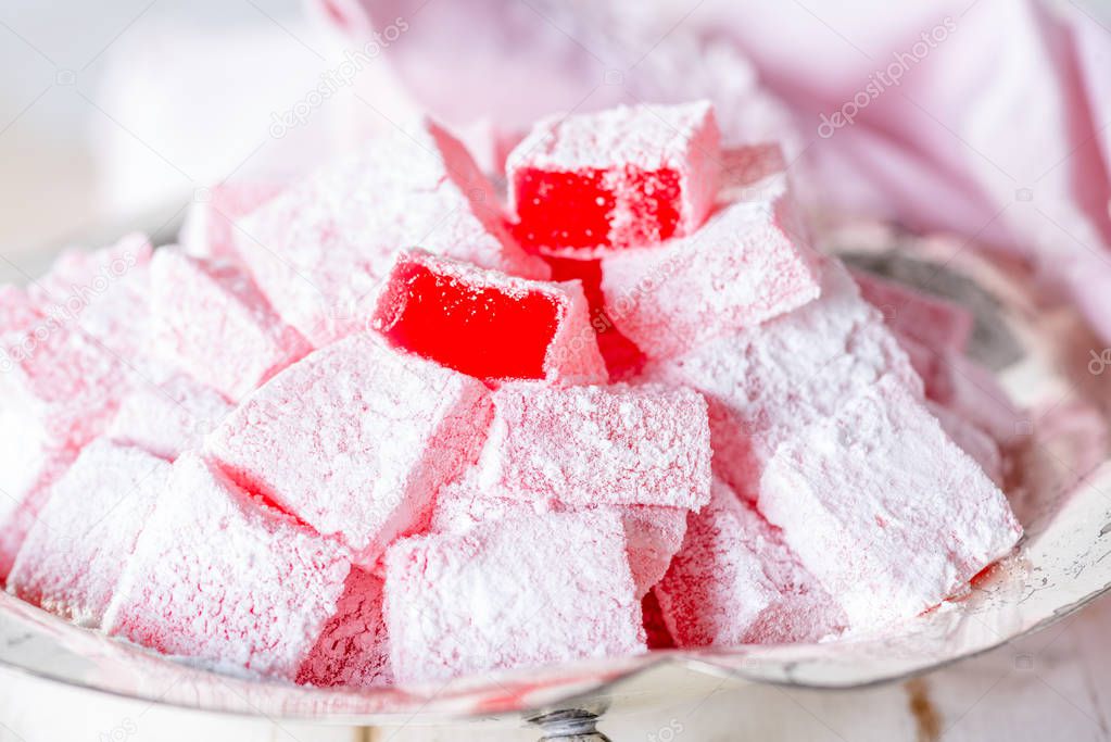 Turkish delight on white wooden table.