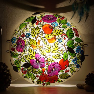 Colorful round hand-painted glass lamp with stained glass paints, with a floral pattern with leaves and flowers clipart