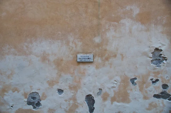 Street sign on the wall of a house in the center of Rome, Italy