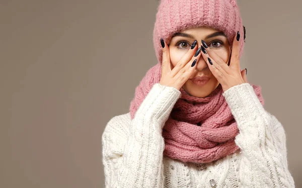 beauty face care portrait of attractive young caucasian woman in warm clothing  studio shot winter hands nails