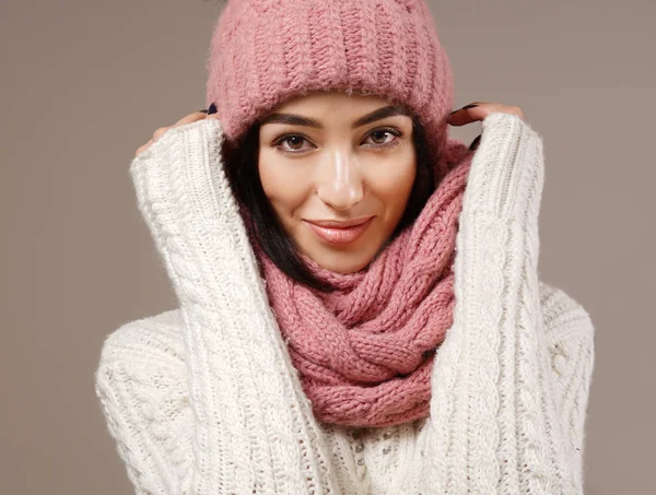 beauty face care portrait of attractive young caucasian woman in warm clothing  studio shot toothy smiling winter