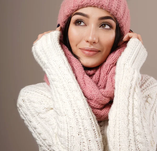 beauty face care portrait of attractive young caucasian woman in warm clothing  studio shot toothy smiling winter