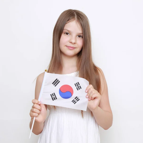 Beautiful little girl and Japanese flag