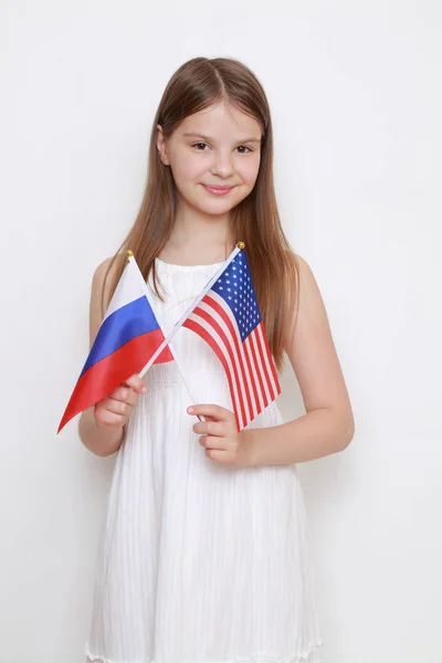 Teen Flicka Som Innehar Ryska Och Amerikanska Flaggor — Stockfoto