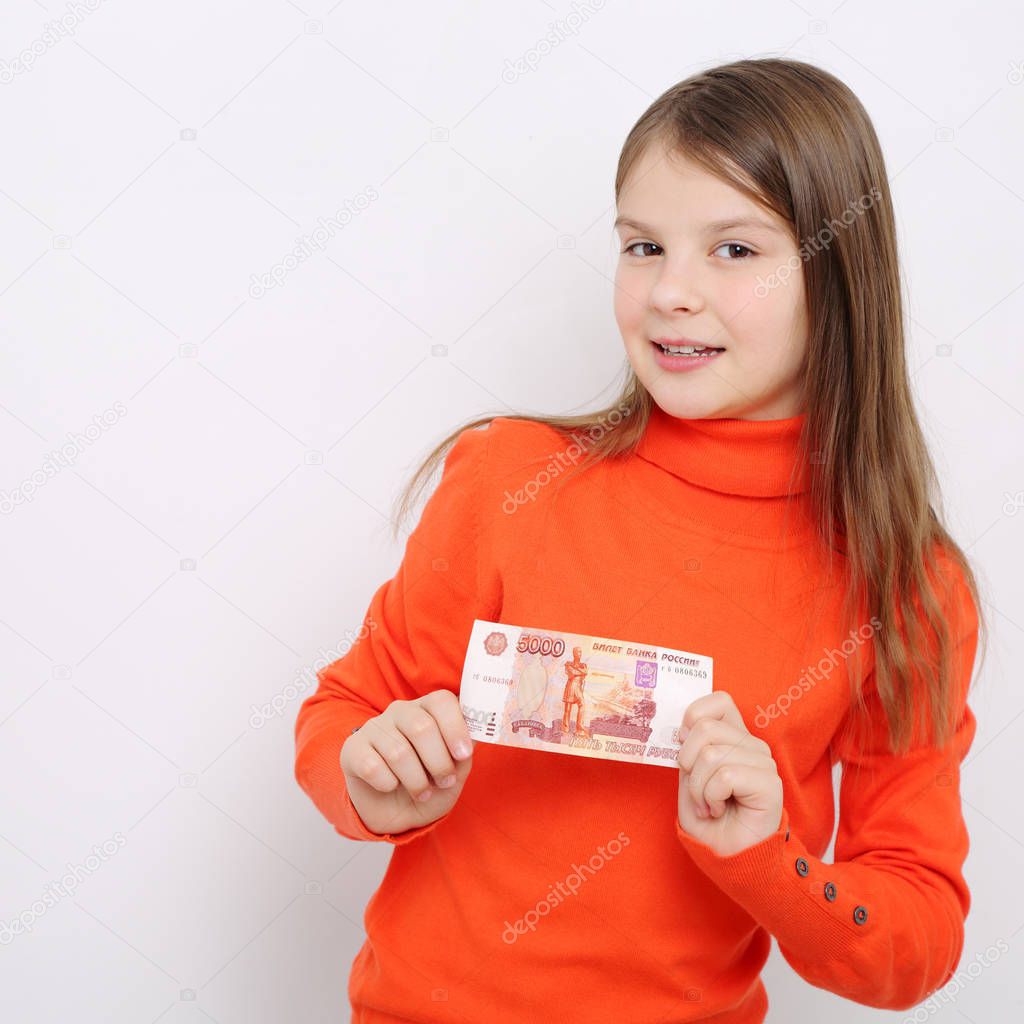 Russian teen girl holding 5000 rubles (five thousands roubles cash money of Russian Federation)