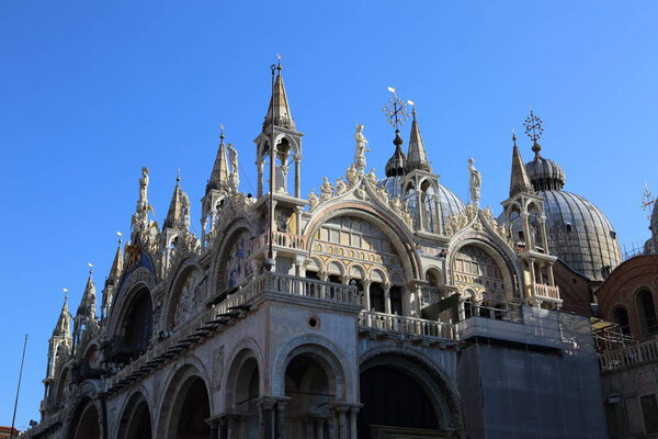 VENICE, ITALY - APRIL 20, 2019: Details of the St. Mark's Cathedral, Venice, Italy. The cathedral church of Venice since 1807. It was built in the 9th century to house relics of St. Mark, and rebuilt in the 11th century.