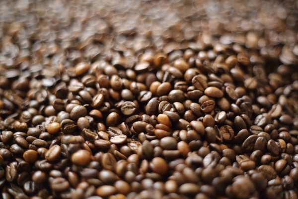 Coffee beans blur testured background. Defocus (or selected focus) coffee texture.
