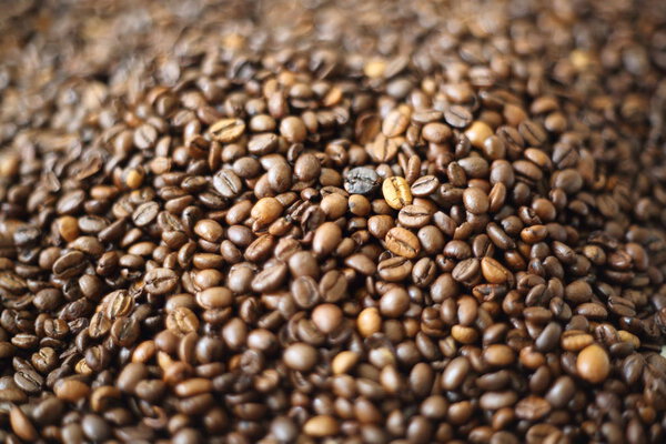 Coffee beans blur testured background. Defocus (or selected focus) coffee texture.