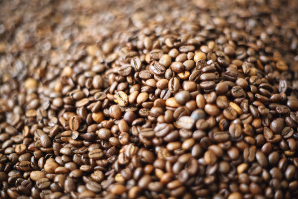 Coffee beans blur testured background. Defocus (or selected focus) coffee texture.